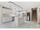 Stylish kitchen with an island, stainless steel appliances, white cabinets, and marble tile flooring at 14010 Pinyon Pine Ln, Charlotte, NC 28215