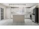 Bright kitchen featuring white cabinets, stainless steel appliances, and an island with stylish pendant lighting at 14010 Pinyon Pine Ln, Charlotte, NC 28215