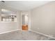 Cozy living room featuring soft carpet and neutral walls, creating a serene and inviting atmosphere at 14010 Pinyon Pine Ln, Charlotte, NC 28215