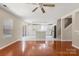 Open-concept living room and kitchen with hardwood floors and modern appliances, creating a welcoming space at 14010 Pinyon Pine Ln, Charlotte, NC 28215