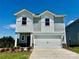 Charming two-story home with a two-car garage, gray siding, and neatly landscaped front yard at 1420 Wildflower St, Newton, NC 28658