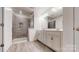 Modern bathroom with a glass-enclosed shower, double vanity, and tile flooring at 14506 Knowledge Cir, Charlotte, NC 28277