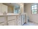 Bathroom features white cabinets, double sinks, and a large mirror, complemented by modern fixtures at 14506 Knowledge Cir, Charlotte, NC 28277