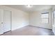A well-lit bedroom featuring hardwood floors, window with blinds, and modern light fixture at 14506 Knowledge Cir, Charlotte, NC 28277