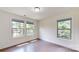 Sunlit bedroom with hardwood floors, modern light, with two windows offering great natural light at 14506 Knowledge Cir, Charlotte, NC 28277