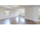 Bonus room featuring hardwood floors, white walls and multiple windows for lots of natural light at 14506 Knowledge Cir, Charlotte, NC 28277