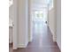 Hallway featuring dark hardwood floors leading to a naturally lit open living space at 14506 Knowledge Cir, Charlotte, NC 28277