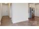 Hallway featuring dark hardwood floors, and access to the kitchen with stainless steel appliances at 14506 Knowledge Cir, Charlotte, NC 28277