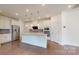 A modern kitchen is equipped with stainless steel appliances and pendant lighting over a kitchen island at 14506 Knowledge Cir, Charlotte, NC 28277