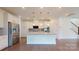 A modern kitchen features stainless steel appliances, a large island, and pendant lighting at 14506 Knowledge Cir, Charlotte, NC 28277