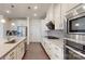The kitchen features white cabinets, stainless steel appliances, and a gray backsplash at 14506 Knowledge Cir, Charlotte, NC 28277