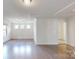 Living room featuring hardwood floors, white walls and recessed lighting at 14506 Knowledge Cir, Charlotte, NC 28277