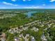 A beautiful neighborhood near a lake with lush green trees and a glimpse of blue sky is seen in this aerial shot at 146 Comata Rd, Mooresville, NC 28117