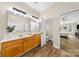Spacious bathroom with double sinks, wood cabinets, and a view to the bedroom at 146 Comata Rd, Mooresville, NC 28117