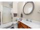Bathroom with a shower, toilet, vanity with sink, and a round mirror at 146 Comata Rd, Mooresville, NC 28117