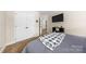 Bedroom featuring closet, TV and shelf with decor, and view to hallway and stairs at 146 Comata Rd, Mooresville, NC 28117