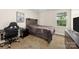 Cozy bedroom with a wooden headboard, a brown blanket, desk, computer chair and a window at 146 Comata Rd, Mooresville, NC 28117