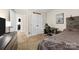 A bedroom featuring closet, bed, desk and computer chair, with view to hallway with access to additional rooms at 146 Comata Rd, Mooresville, NC 28117