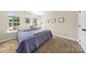 Well-lit bedroom with comfortable bedding, plush pillows, and natural light from two windows at 146 Comata Rd, Mooresville, NC 28117