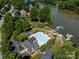 Community pool with a view of the lake, boat docks, parking lot, and surrounding lush greenery at 146 Comata Rd, Mooresville, NC 28117