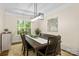 Elegant dining area with modern light fixture and natural light at 146 Comata Rd, Mooresville, NC 28117