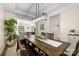 Bright dining room features a modern light fixture, wooden table and bench seating, and a large plant at 146 Comata Rd, Mooresville, NC 28117