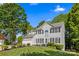 Beautiful two-story home boasts a manicured lawn, attached garage, and classic architectural details at 146 Comata Rd, Mooresville, NC 28117