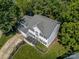 Aerial view of a two-story house with great curb appeal and a well manicured lawn with trees and black mulch at 146 Comata Rd, Mooresville, NC 28117