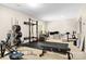 Basement gym featuring weights, squat rack, bench, and computer desk for a home fitness setup at 146 Comata Rd, Mooresville, NC 28117