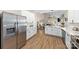 Open concept kitchen and living room with an island, white cabinets and stainless steel appliances at 146 Comata Rd, Mooresville, NC 28117