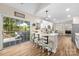 Bright kitchen features seating at the island, white cabinetry, and a view of the outdoor patio at 146 Comata Rd, Mooresville, NC 28117