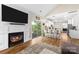 Inviting living room features a fireplace and large sliding glass doors for natural light at 146 Comata Rd, Mooresville, NC 28117