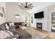 Living room with vaulted ceiling, fan, fireplace, large sectional, and plenty of natural light at 146 Comata Rd, Mooresville, NC 28117