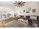Open concept living room and kitchen features vaulted ceilings, fan, and plenty of comfortable seating at 146 Comata Rd, Mooresville, NC 28117