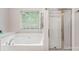 Bright bathroom with a large soaking tub and a separate glass-enclosed shower at 15037 Taylor Ridge Ln # 25, Charlotte, NC 28273