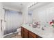 Well-lit bathroom with dual sinks, wood cabinets, and stylish mirror above the vanity at 15037 Taylor Ridge Ln # 25, Charlotte, NC 28273