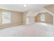 Large carpeted bonus room featuring bright windows and neutral walls, ready for customization at 15037 Taylor Ridge Ln # 25, Charlotte, NC 28273