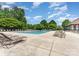 Community pool with lounge chairs and tables, perfect for relaxing and enjoying the sun at 15037 Taylor Ridge Ln # 25, Charlotte, NC 28273