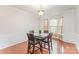 Elegant dining room with a modern table set, chandelier, wainscoting, and natural light at 15037 Taylor Ridge Ln # 25, Charlotte, NC 28273