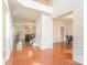 Bright foyer with hardwood floors, a staircase, and views of the living and dining areas at 15037 Taylor Ridge Ln # 25, Charlotte, NC 28273