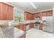 Well-lit kitchen with granite countertops, stainless steel appliances, and wood cabinets at 15037 Taylor Ridge Ln # 25, Charlotte, NC 28273