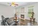 Cozy living room features fireplace, ceiling fan, and marble floors for warmth and comfort at 15037 Taylor Ridge Ln # 25, Charlotte, NC 28273