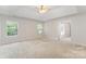 Spacious main bedroom offers tray ceiling, ceiling fan, and bright windows for comfort and relaxation at 15037 Taylor Ridge Ln # 25, Charlotte, NC 28273