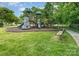 Community playground with swings, slide, and climbing structure, surrounded by lush greenery at 15037 Taylor Ridge Ln # 25, Charlotte, NC 28273