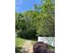 Community walkway with a white fence and lush trees, surrounded by green grass and a colorful bush at 15037 Taylor Ridge Ln # 25, Charlotte, NC 28273