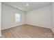 Bright bedroom with natural light, neutral walls, and wood-look flooring at 1505 Harper Landing Blvd, Stanley, NC 28164