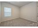 Clean bedroom with neutral walls, plush carpeting, and a window with white blinds at 1505 Harper Landing Blvd, Stanley, NC 28164
