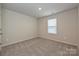 Bedroom featuring neutral walls and carpet, a window, and ample closet space at 1505 Harper Landing Blvd, Stanley, NC 28164