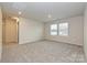 Large bonus room featuring neutral walls, plush carpeting, and a well-lit atmosphere from the windows at 1505 Harper Landing Blvd, Stanley, NC 28164