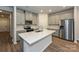 Modern kitchen with stainless steel appliances, gray cabinets, quartz countertops and an island with sink at 1505 Harper Landing Blvd, Stanley, NC 28164